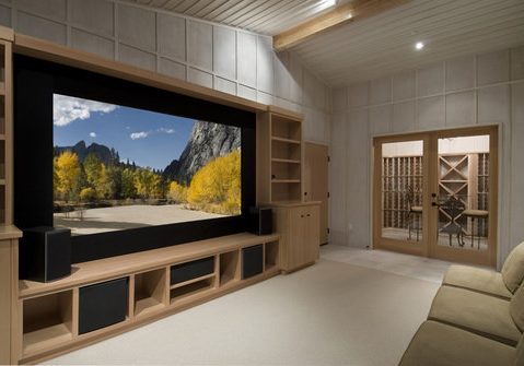 Home theater with wine tasting room, big screen, wood cabinets,photo on screen is one of my shots from yosemite